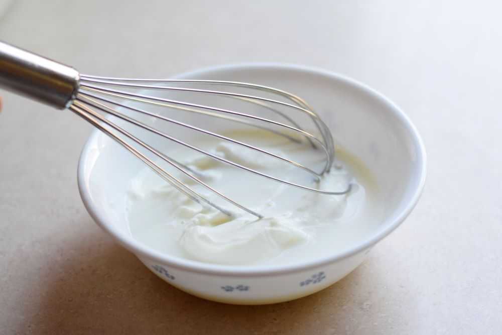 Milk in a bowl with a whisk