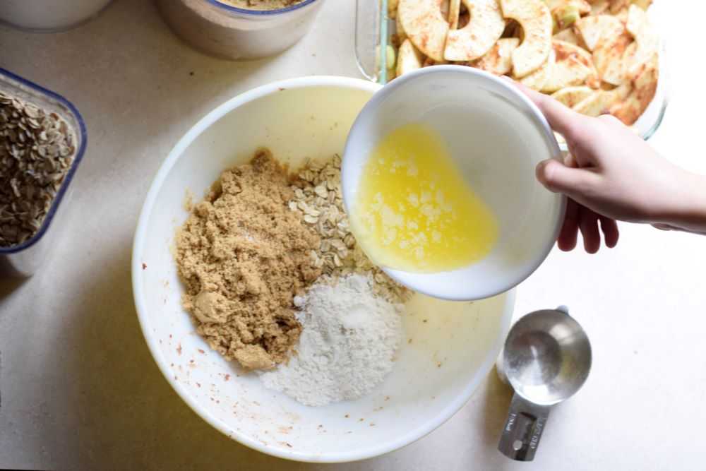 Add the butter to the apple crisp topping.