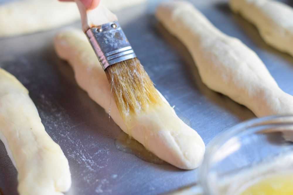 Brush the breadsticks with melted butter