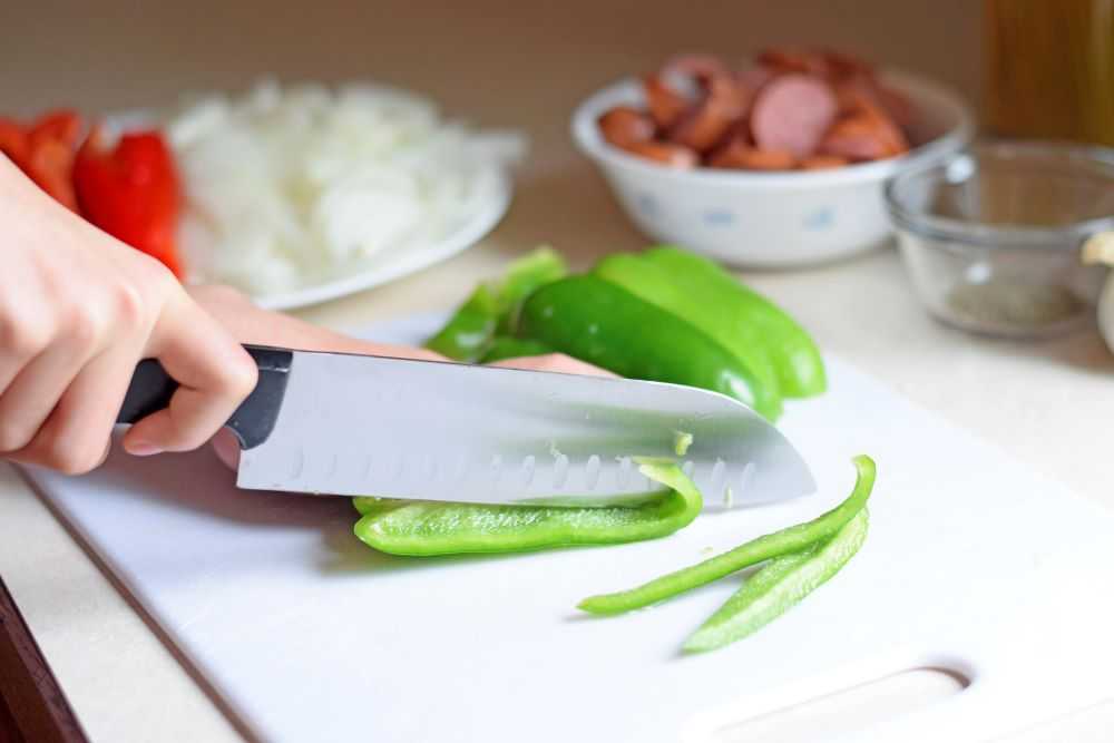 Chopping green peppers.