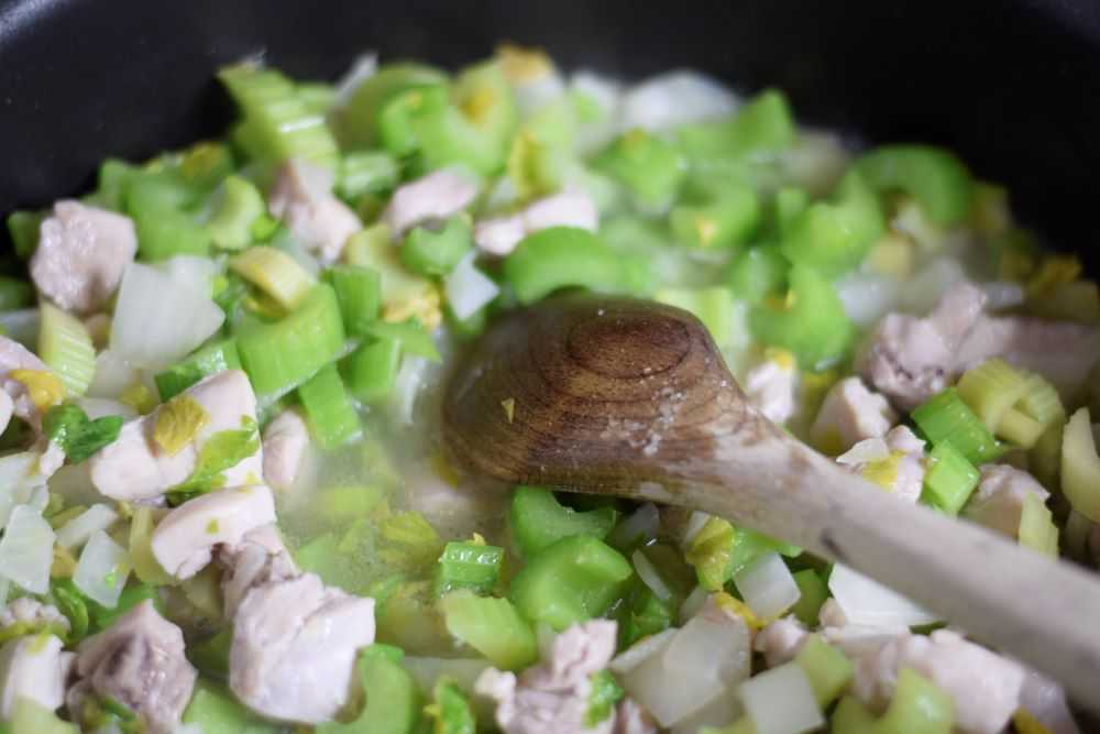 Chicken, onion, and celery in a pan